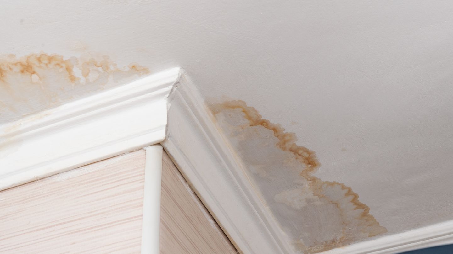 Damaged roof with water leaking through